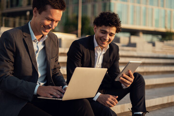 Partner economists surf the Internet. Work financiers colleagues together on a new startup. Male entrepreneurs go to a new office.