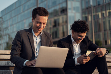 Financiers work together on a new startup. Male entrepreneurs go to a new office. Economists surf the Internet.