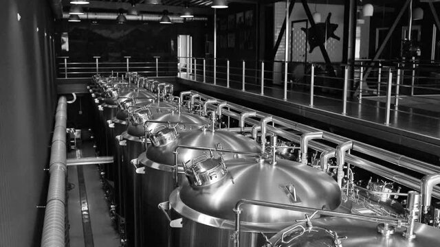 Private microbrewery. Modern beer plant with brewering kettles, tubes and tanks made of stainless steel