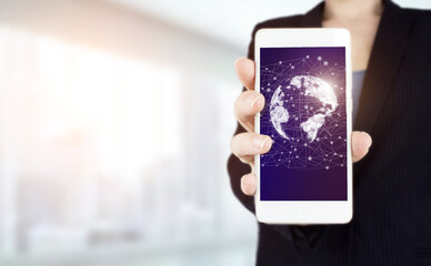 Concept on business, politics, ecology and media. Hand hold white smartphone with digital hologram world, earth, map, globe sign on light blurred background. Global technologies concept.