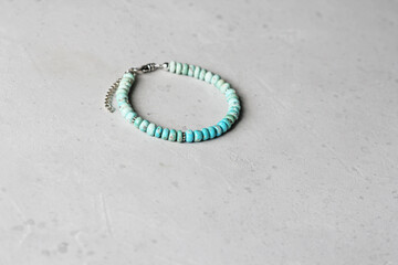 Turquoise bracelet. Bracelet made of stones on hand from natural stone Turquoise. Bracelet made of natural stones. Handmade jewelry. Handmade bracelets on light modern background