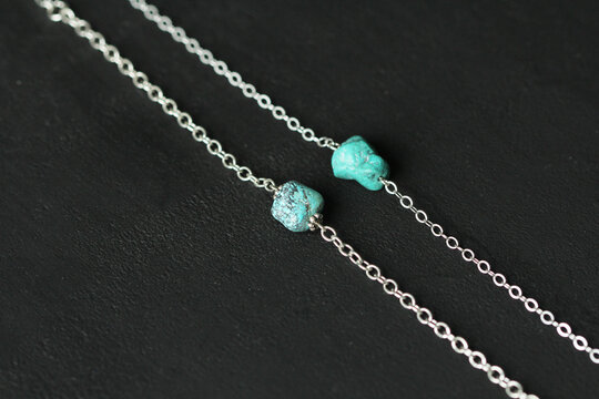 Turquoise nugget two bracelets on a silver chain, on a black modern background. Bracelet made of stones on hand from natural stone Turquoise. Handmade Bracelet made of natural stones