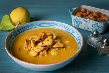 Seafood soup, based on prawns, mussels, clams, hake and squid, served with fried bread and lemons.