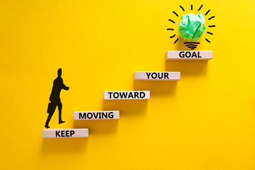 Keep moving toward your goal symbol. Wooden blocks with words Keep moving toward your goal....
