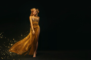 Portrait Closeup Beauty fantasy woman, face in gold paint. Golden shiny skin. Fashion model girl,...
