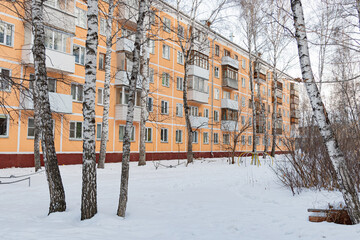 Winter cityscape. Residential buildings and trees