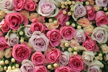 Pink and purple roses in a wedding centerpiece