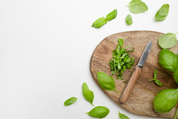 Fresh organic basilic leaves on a wooden surface. Herbs and spices for cooking