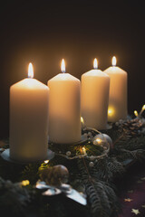 Fourth advent, four candles - candlelight on dark brown panorama background - advent banner....
