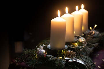 Fourth advent, four candles - candlelight on dark brown panorama background - advent banner....