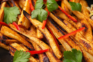 Spicy roast parsnips with zesty yogurt dip, vegetarian food.