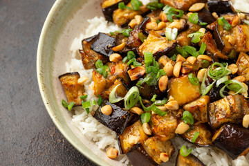 Asian Eggplant with rice, peanuts and spring onion. Healthy food.