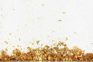 Gold (bronze) glitter shine piece of foil. Abstract light blink sparkle wall backgound.