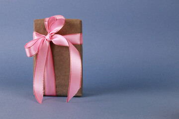 Brown gift box with pink bow.