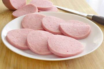 Greek Parizaki pork slices on a white plate. Very popular charcuterie products in Greece.