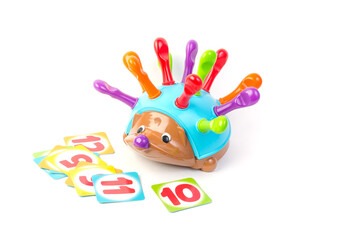 Childrens toy for the development of motor skills in the form of a hedgehog with and cards on a white background.