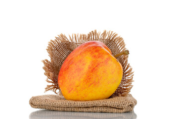 One juicy red apple with a jute bag, close-up, isolated on white.