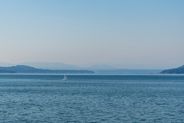 strait of Georgia between Vancouver and Victoria with small islands boats and blue sky