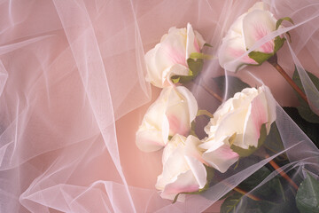 A bouquet of white roses covered with organza. Selective focus.
