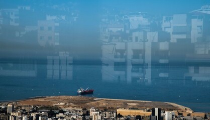 Fototapeta premium ship at the port of Beirut viewed through a window with reflection