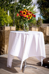 Vase of fresh flowers on a white tablecloth table