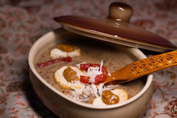 Hot and tasty winter dish - pureed forest mushrooms cream soup with cheese, toasted bread, sausages and mustard