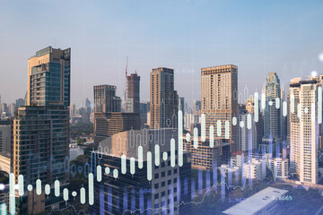Market behavior graph hologram, sunset panoramic city view of Bangkok, popular location to achieve financial degree in Southeast Asia. The concept of financial data analysis. Double exposure.