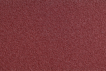 Fototapeta premium Burgundy red texture of uniform color. Sharpness in the center, blur on the sides.