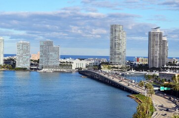 Fototapeta na wymiar Eastern end of the MacArthur Causeway,and luxury Miami Beach,Florida condo towers overlooking Biscayne Bay .