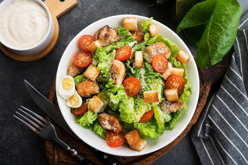 Caesar salad with chicken fillet, cherry tomatoes and croutons, traditional Italian food