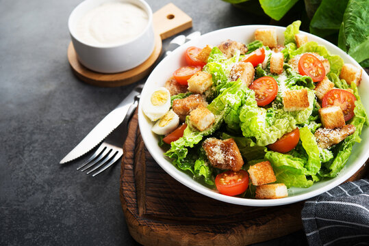 Caesar salad with chicken fillet, cherry tomatoes and croutons, traditional Italian food