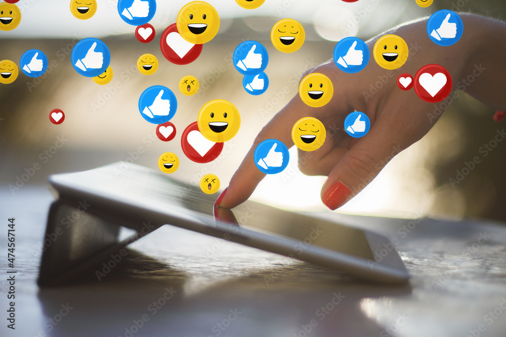 Poster close up of female hand using tablet on desktop with social media icons. blurry background. communic