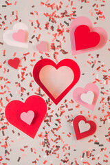 Heart shapes cut of paper with confetti