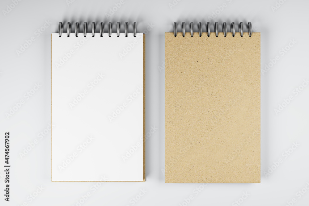 Poster Top view and close up of two white and brown spring notepads on white desktop background. Mock up place for your advertisement. Education, work, supplies and stationery concept. 3D Rendering.
