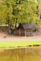 Wooden gazebo for the nursery at the edge of the forest and pond