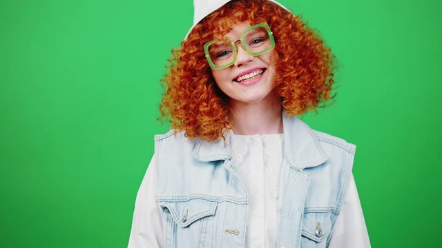 I choose you. Young playful redhead woman in glasses and panama hat dancing and making gotcha gesture