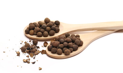 Allspice, pimento spice, Jamaican pepper and shavings in wooden spoon isolated on white  