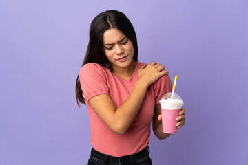 Teenager girl holding a strawberry milkshake suffering from pain in shoulder for having made an effort