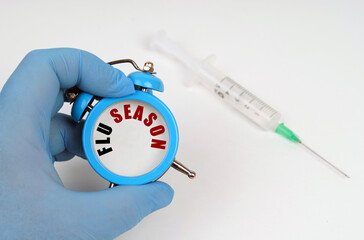 There is a syringe on the table, an alarm clock in his hand with an inscription on the scoreboard -...
