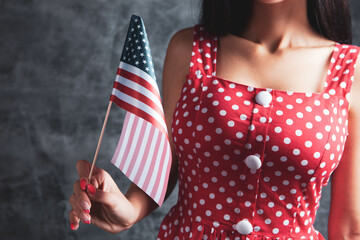 young woman holding the flag of america