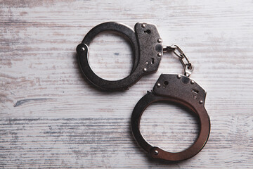 handcuffs on a wooden table