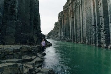 traveler girl in The Green River Through Studlagil basalt canyon, Iceland