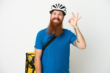 Young reddish caucasian man with thermal backpack isolate don white background showing ok sign with fingers