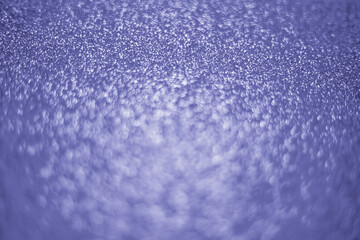 The color of 2022. Abstract background tinted with fashionable color. Sparkling texture of sequins and bokeh.