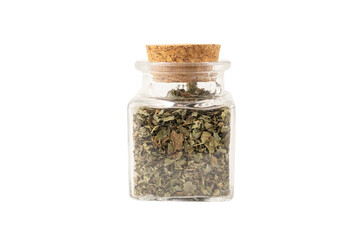 Dried Lemon balm (Melissa officinalis) herb in a glass jar isolated on white background.