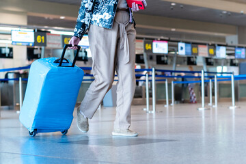 people wearing medical masks walking with luggage bags suitcases at the airport travel concept. High quality photo