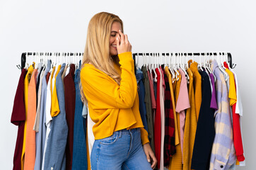 Young Uruguayan blonde woman in a clothing store laughing