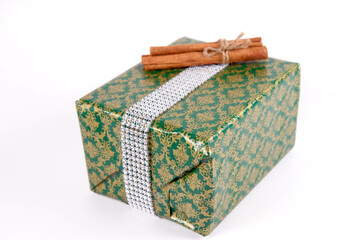 Christmas gift wrapped and decorated with cinnamon sticks