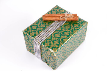 Christmas gift wrapped and decorated with cinnamon sticks
