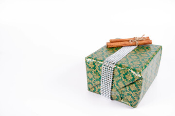 Christmas gift wrapped and decorated with cinnamon sticks